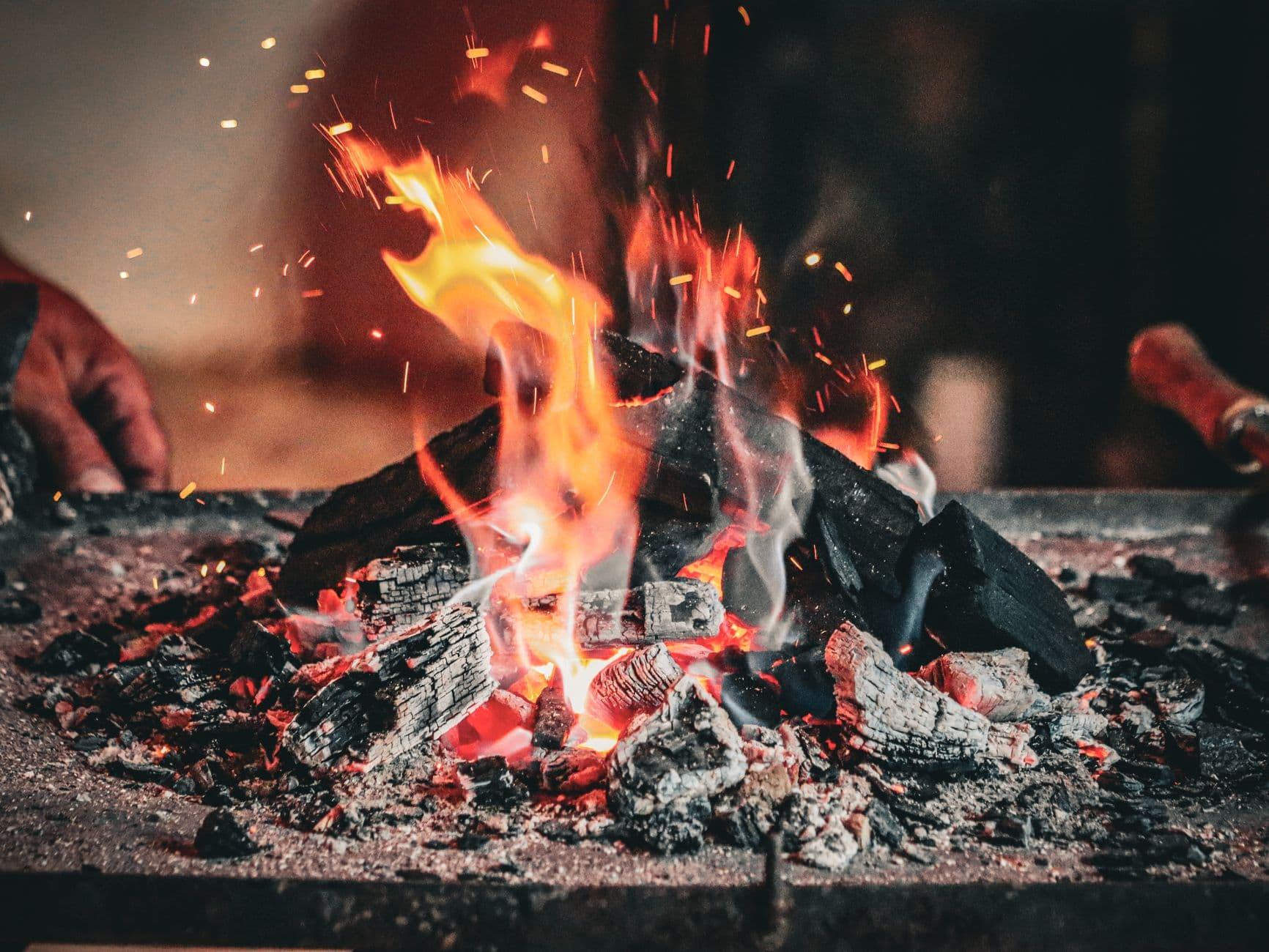 Intense flames and glowing charcoal create a warm and fiery ambiance.